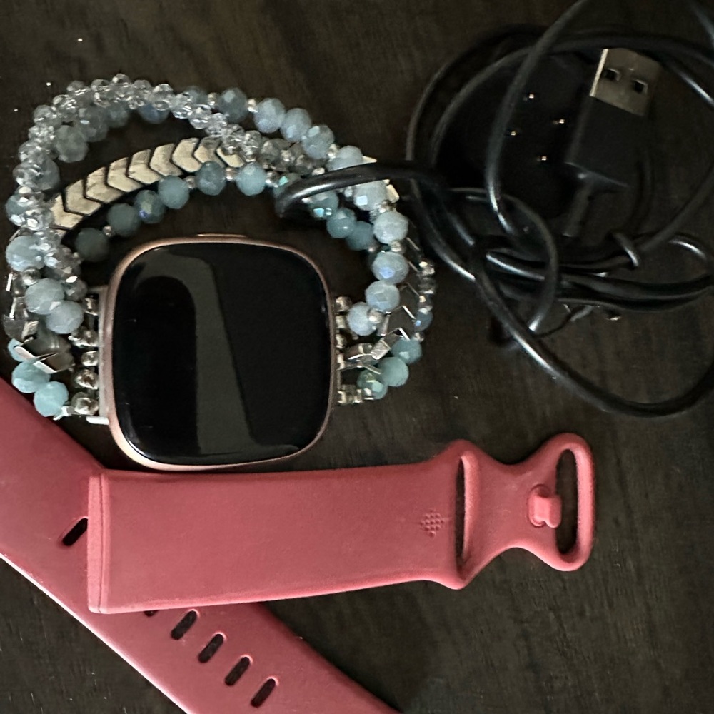 Fitbit Smartwatch with Black Display and Pink Band